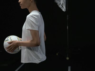 A side view of a man holding a difficult balance pose with focus and determination.